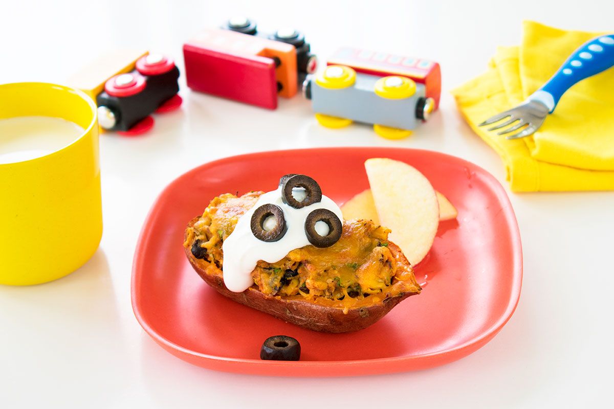 stuffed potato on plate with cream and black olives hero toy trucks